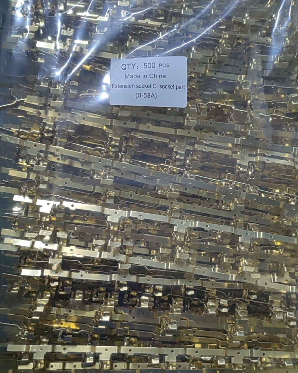 Brass parts bagged with a quantity label for dispatch