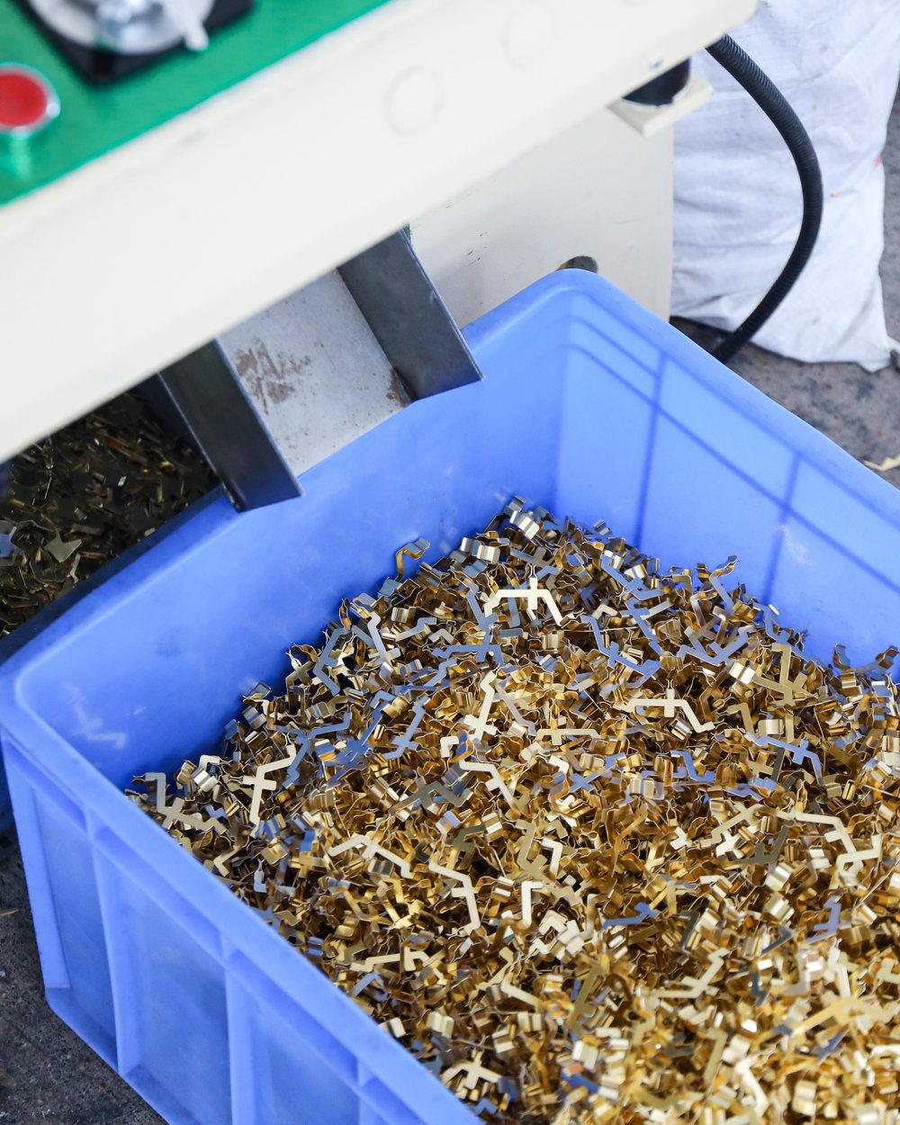 Bin of brass parts collected after a production run